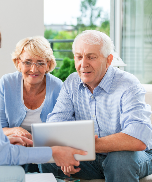 Elderly couple consulting with insurance agent at J. Ray Insurance in Atmore, AL.